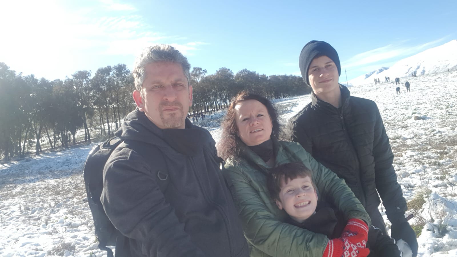 A wider family photo in the snow