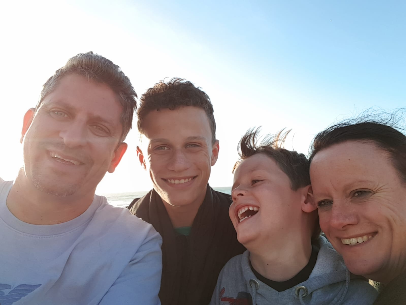 A happy family selfie by the sea